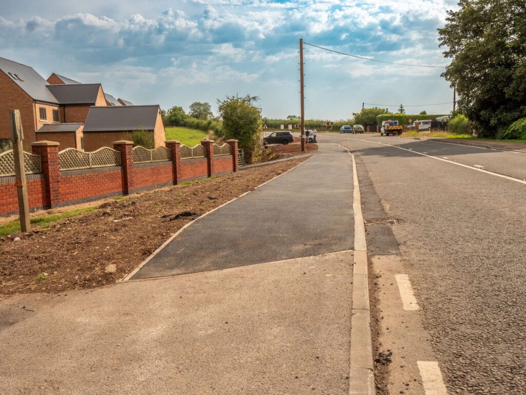 New asphalt surfacing and kerbs provide a clean roadside finish in Gloucestershire.