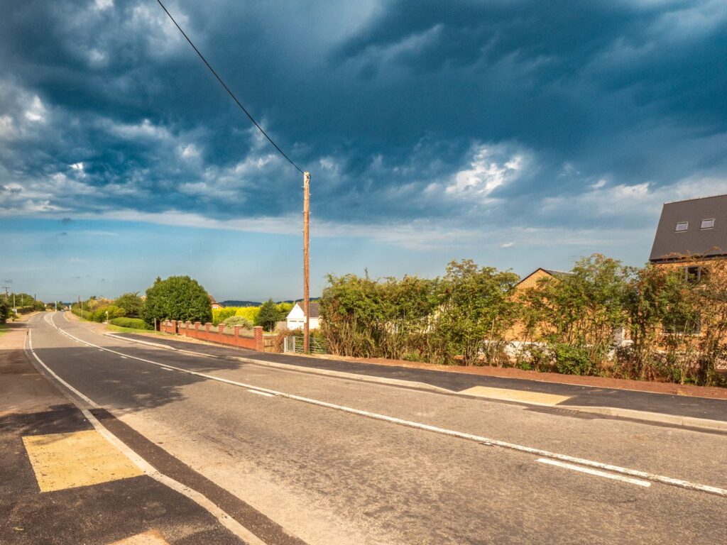 Completed roads and sewers improvements in Gloucestershire show a new footway, kerbs, tactile paving and drainage.