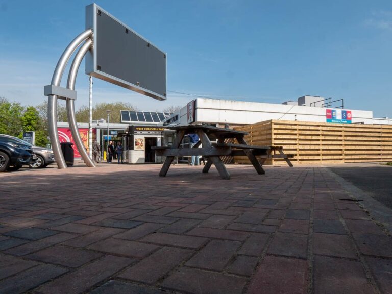 Herringbone block paving forecourt with picnic benches at Moto Leigh Delamere Services.
