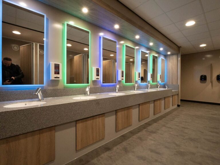 Refurbished customer toilets with lit mirrors at Moto Leigh Delamere Services.