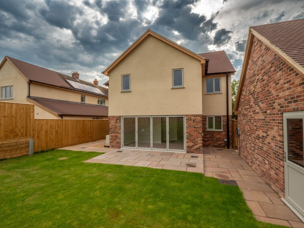 Sandstone garden patio paving and side access complete the outdoor space at this Gloucestershire new build.