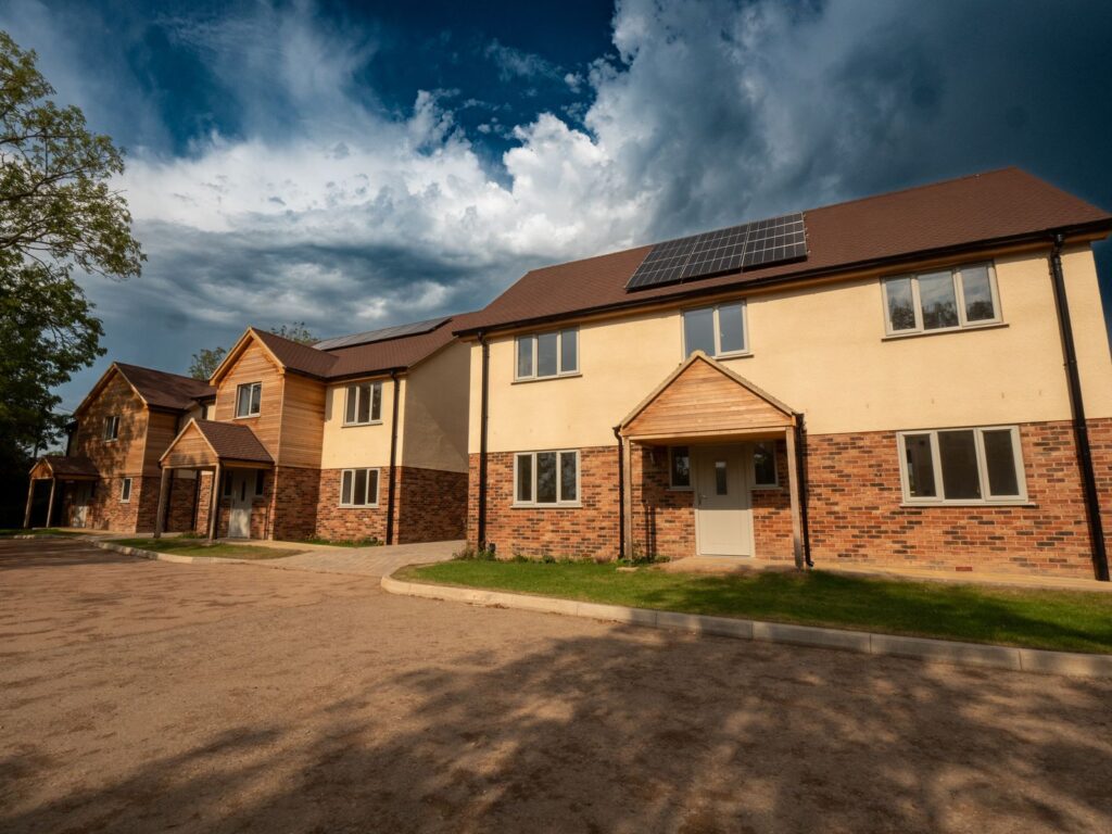 New-build homes and a kerbed access road completed as part of a Gloucestershire construction project.