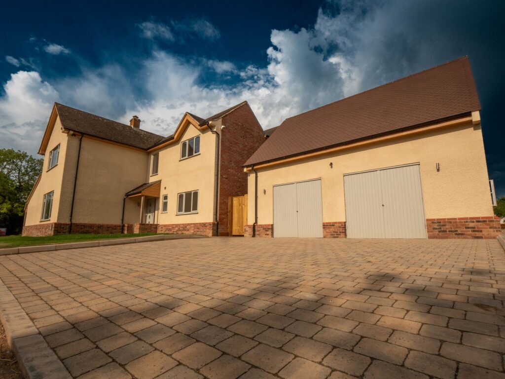A large block-paved driveway and kerb edging installed for a new home in Gloucestershire.