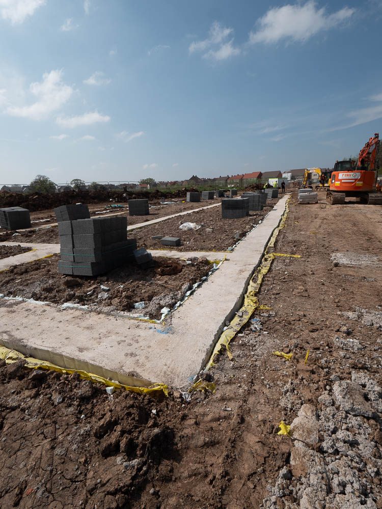 Concrete strip foundations set out on a residential development site.