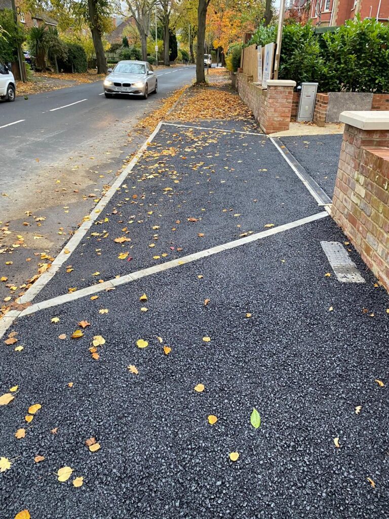 Tarmac driveway entrance with dropped kerb and edging.