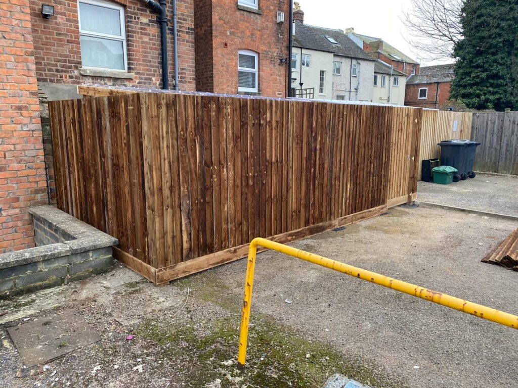 Timber boundary fence along a residential courtyard.